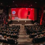 Opening ceremony of Game Changer Zagreb 5.0 at CineStar cinemas in Z Centar with a packed audience facing a red stage screen
